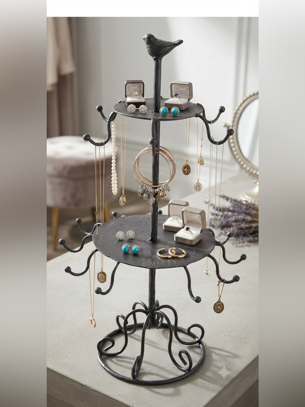 Black Metal Tiered Stand jewelry stand with bird on top of stand